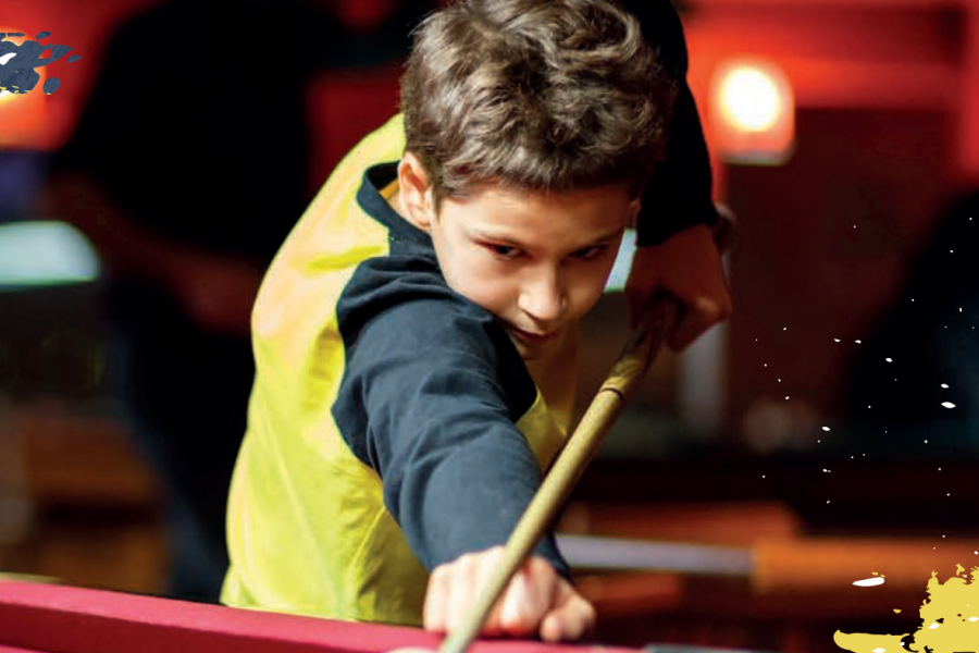 kid playing pool/snooker