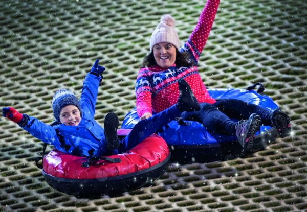 Two people snowtubing at Craigavon Golf and Ski Centre.