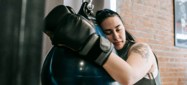 Girl resting on a punch bag