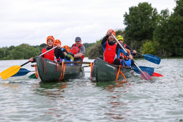 a group of people canoeing