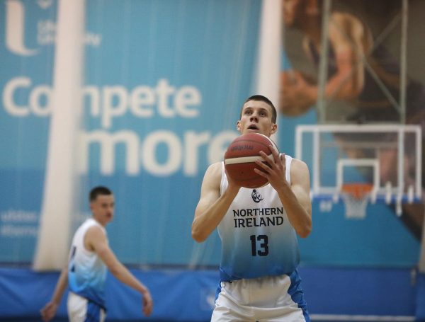 Young male basketball player ready to take a shot on net.