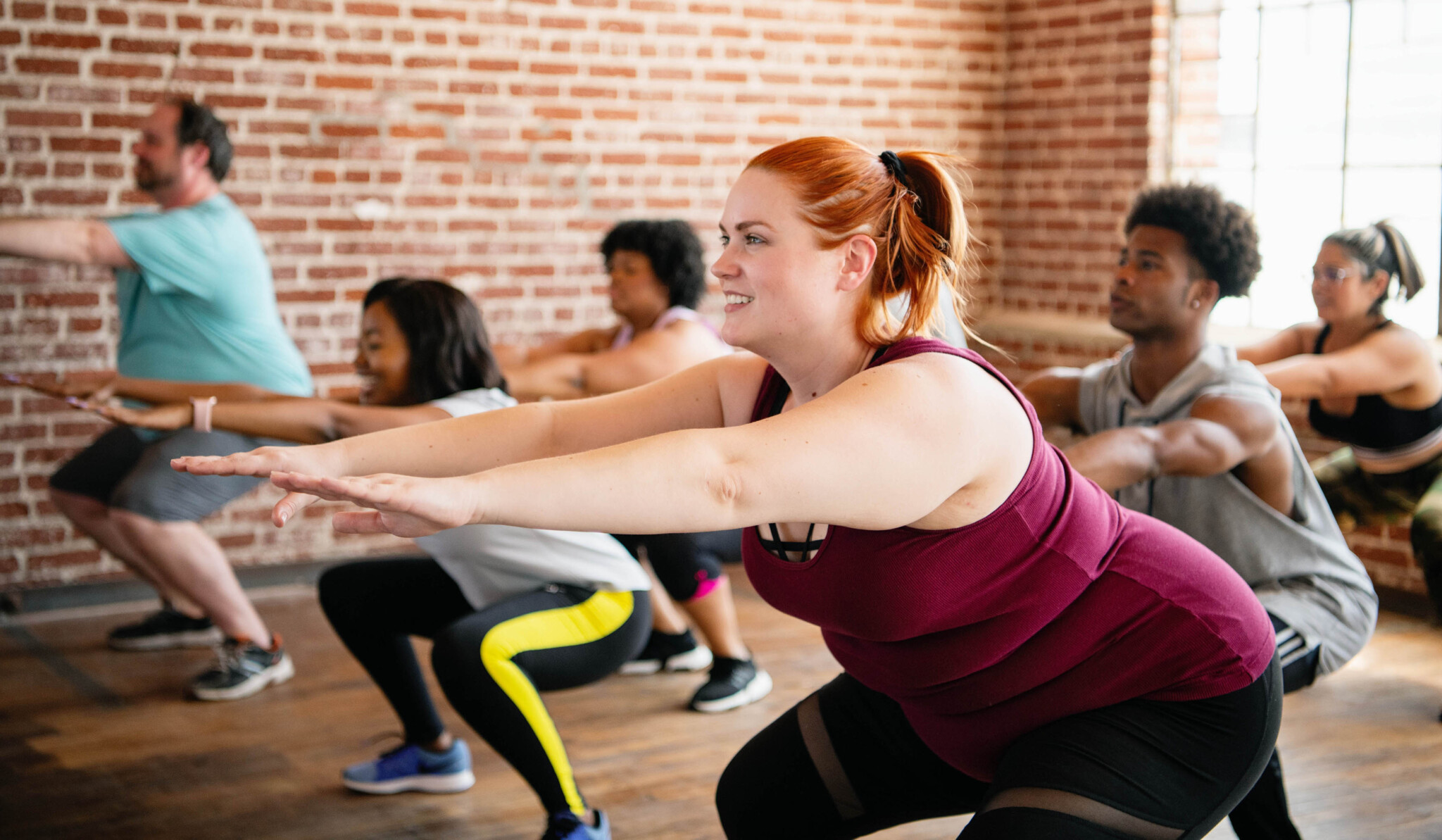 A,Diverse,Group,Of,Men,And,Women,Doing,Squats,In